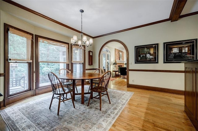 3030 Spalding Dr, Sandy Springs, GA 30350 - dining room featuring arched walkways, crown molding, a chandelier, and light wood finished floors