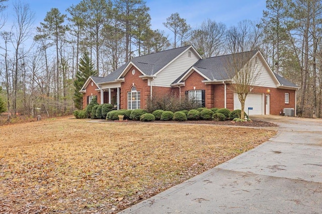 view of front of home with a garage and central air condition unit