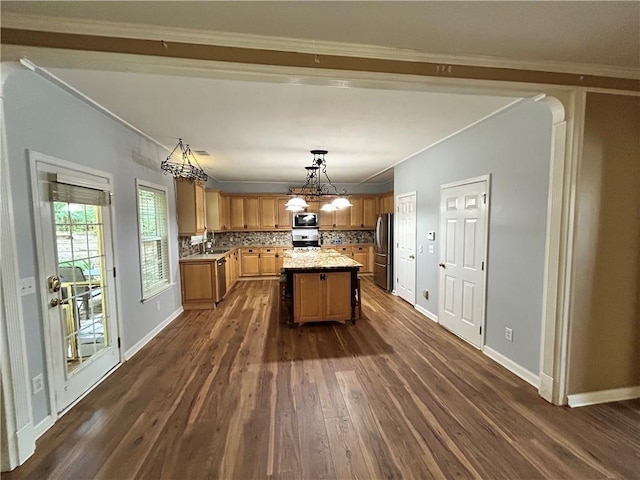 1038 Island View Ct, Buford, GA 30518 - kitchen with appliances with stainless steel finishes, dark wood finished floors, ornamental molding, a chandelier, and decorative backsplash
