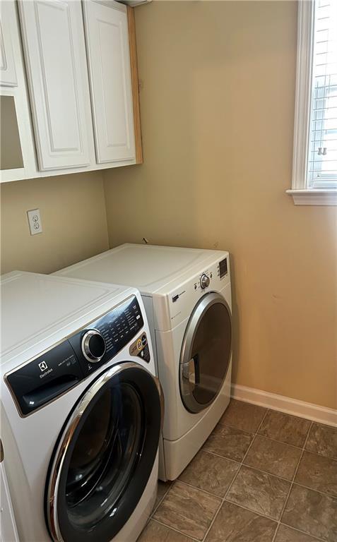 1038 Island View Ct, Buford, GA 30518 - laundry room featuring independent washer and dryer and cabinet space