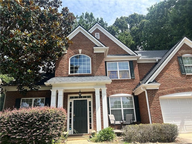 1038 Island View Ct, Buford, GA 30518 - view of front of home with brick siding, a garage, and a porch