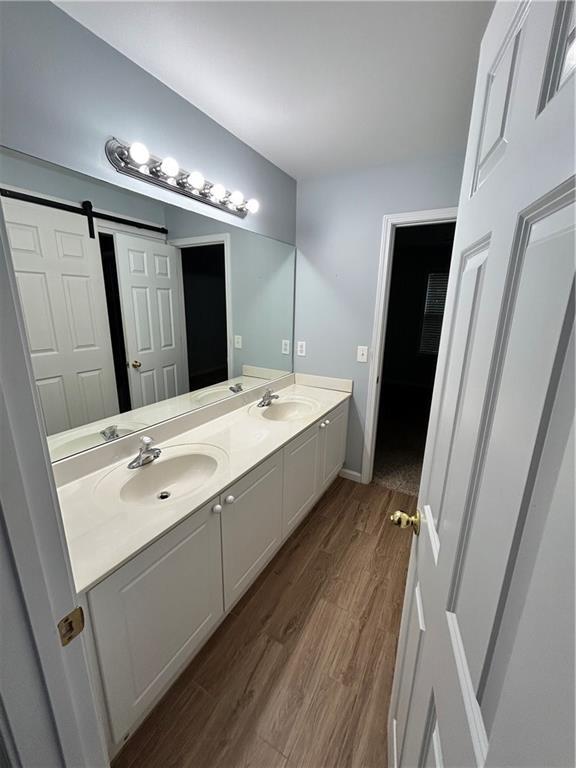 1038 Island View Ct, Buford, GA 30518 - full bath with double vanity and wood finished floors
