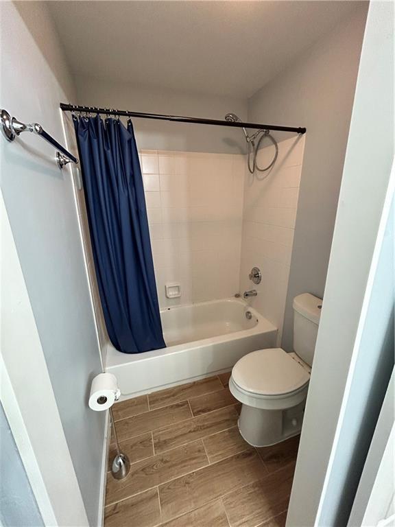 1038 Island View Ct, Buford, GA 30518 - full bath featuring shower / bath combo with shower curtain and wood finish floors