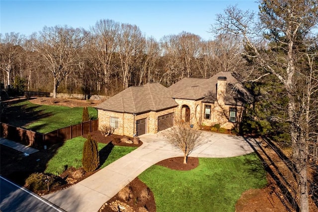 view of front of property with a garage and a front lawn