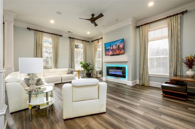 living room with hardwood / wood-style flooring, ornamental molding, decorative columns, and ceiling fan