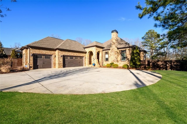 view of front of home featuring concrete driveway, a chimney, an attached garage, fence, and a front yard