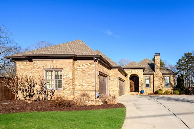 view of front of property with a garage and a front yard