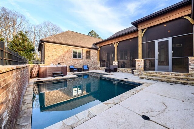 view of pool with a hot tub