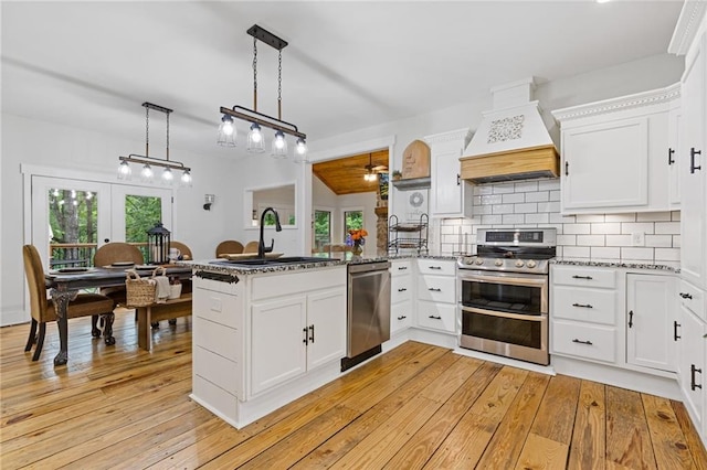 6224 Eagle Ct, Gainesville, GA 30506 - kitchen featuring appliances with stainless steel finishes, custom range hood, a sink, ceiling fan, and a peninsula