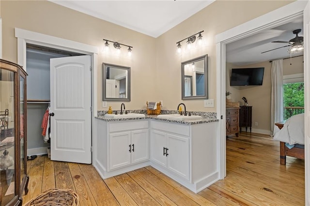 6224 Eagle Ct, Gainesville, GA 30506 - ensuite bathroom with double vanity, hardwood / wood-style floors, a ceiling fan, and baseboards