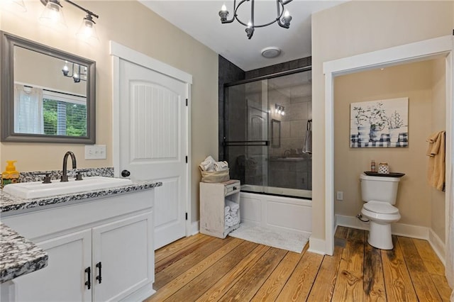 6224 Eagle Ct, Gainesville, GA 30506 - bathroom featuring wood finished floors, toilet, combined bath / shower with glass door, vanity, and a chandelier