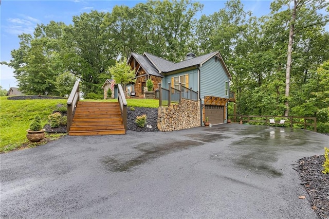 6224 Eagle Ct, Gainesville, GA 30506 - view of side of home with stairs, asphalt driveway, an attached garage, stone siding, and board and batten siding