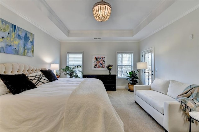 bedroom with a raised ceiling, carpet flooring, and crown molding