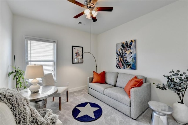 living area featuring carpet, visible vents, ceiling fan, and baseboards