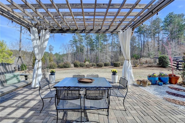 view of patio with outdoor dining area and a pergola