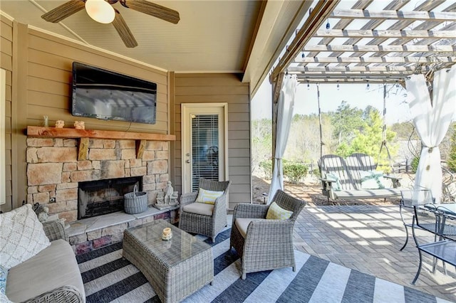 view of patio with ceiling fan, an outdoor living space with a fireplace, and a pergola