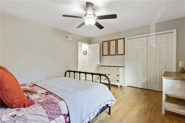 bedroom featuring ceiling fan, a closet, and light wood-type flooring