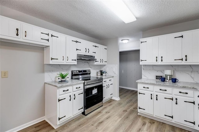 kitchen featuring light hardwood / wood-style flooring, backsplash, light stone counters, white cabinets, and stainless steel range with electric cooktop