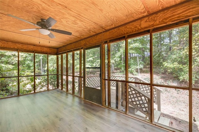 unfurnished sunroom featuring wood ceiling and ceiling fan