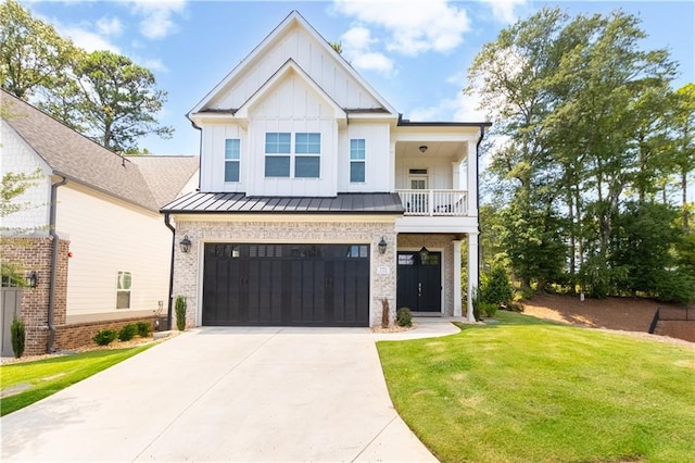 view of front of home featuring a garage, a balcony, and a front yard