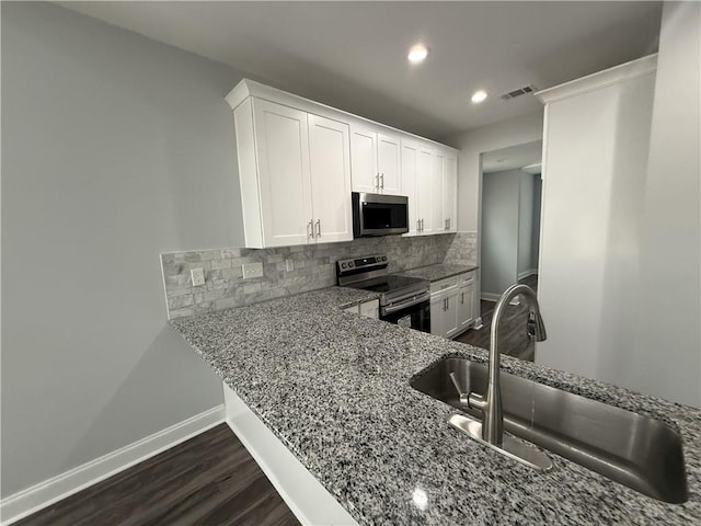 kitchen featuring white cabinetry, sink, backsplash, light stone counters, and stainless steel appliances