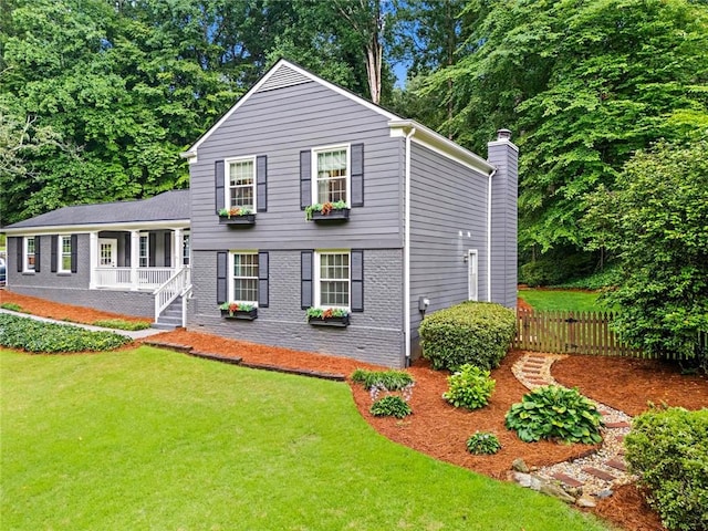 261 Lamplighter Ln SE, Marietta, GA 30067 - view of front facade with a porch, brick siding, and a chimney