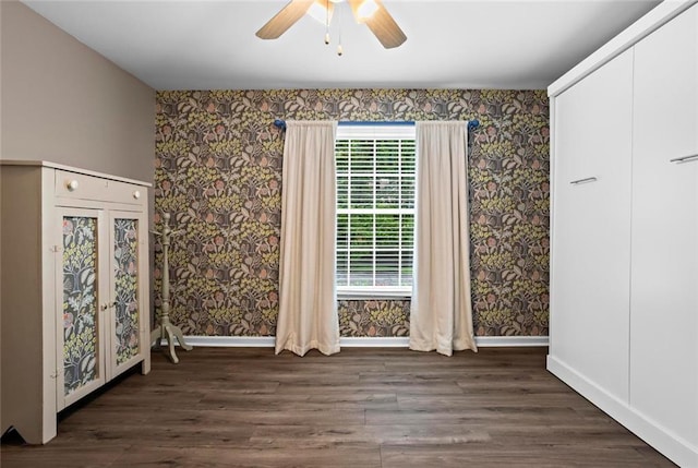 261 Lamplighter Ln SE, Marietta, GA 30067 - unfurnished bedroom with wallpapered walls, wood finished floors, and ceiling fan
