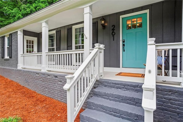 261 Lamplighter Ln SE, Marietta, GA 30067 - property entrance with covered porch and board and batten siding