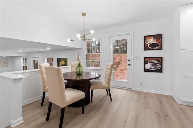 dining space featuring a chandelier and light wood-type flooring