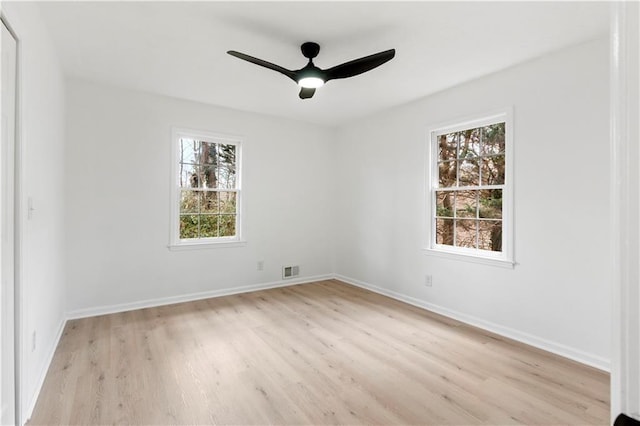 unfurnished room with ceiling fan, a healthy amount of sunlight, and light wood-type flooring