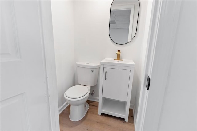 bathroom with vanity, wood-type flooring, and toilet