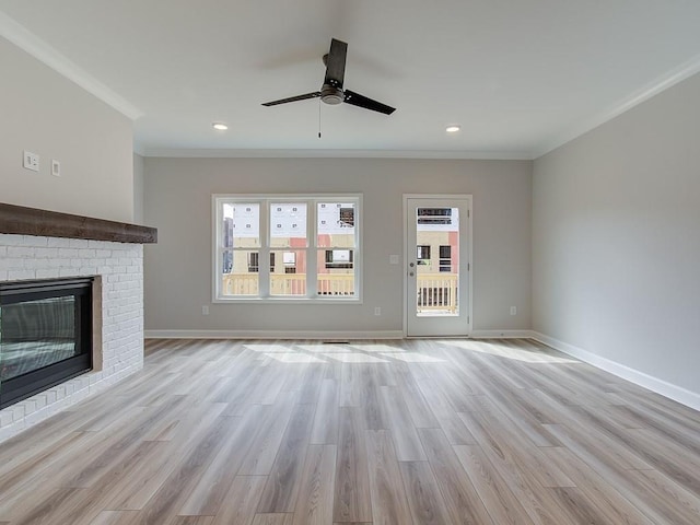 1976 Deco Dr, Kennesaw, GA 30144 - unfurnished living room with a ceiling fan, ornamental molding, light wood-style flooring, and a brick fireplace