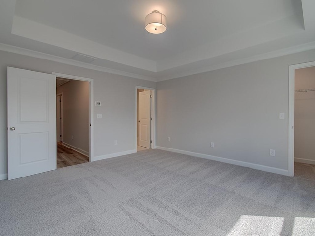 1976 Deco Dr, Kennesaw, GA 30144 - unfurnished bedroom featuring crown molding, a raised ceiling, carpet floors, and a spacious closet