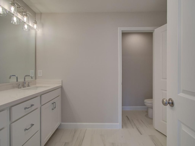 1976 Deco Dr, Kennesaw, GA 30144 - bathroom with vanity, marble finish floor, baseboards, and toilet