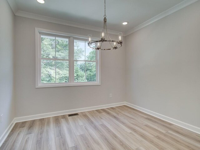 1976 Deco Dr, Kennesaw, GA 30144 - unfurnished room featuring crown molding, baseboards, light wood finished floors, and a notable chandelier