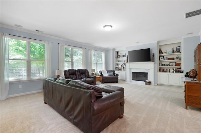 living room with built in shelves, crown molding, and light carpet