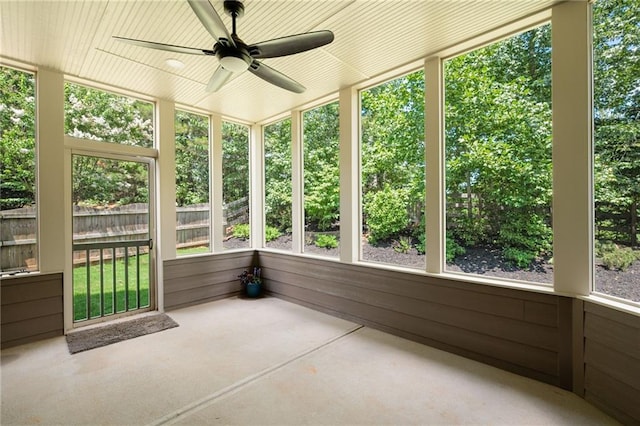 unfurnished sunroom with ceiling fan