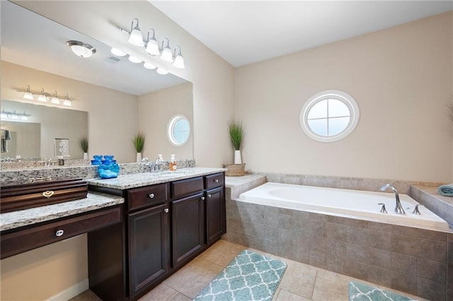 bathroom featuring vanity, tiled tub, and tile patterned floors