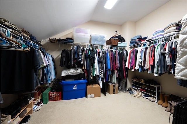 spacious closet with carpet floors and vaulted ceiling