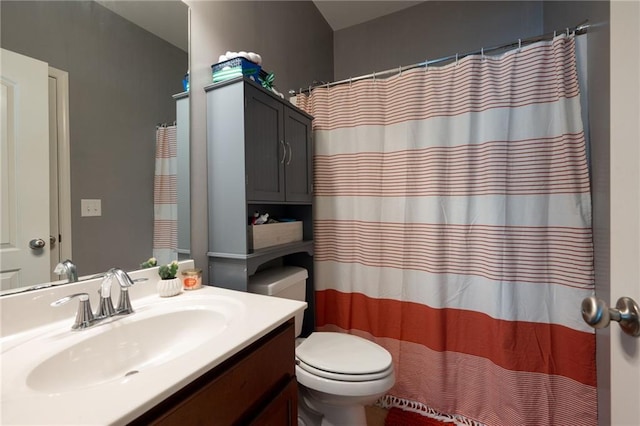 bathroom featuring toilet, vanity, and a shower with curtain