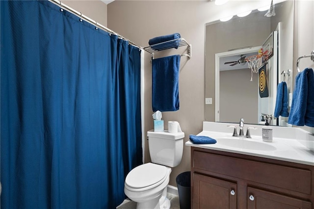 bathroom with toilet, ceiling fan, and vanity