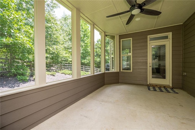 unfurnished sunroom featuring ceiling fan