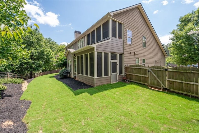 back of property with a sunroom and a lawn