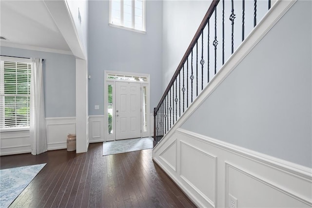 foyer featuring dark hardwood / wood-style floors and ornamental molding