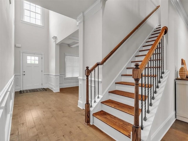 105 Lighthouse Cv SW, Adairsville, GA 30103 - entrance foyer featuring wainscoting, wood finished floors, stairs, a high ceiling, and a decorative wall