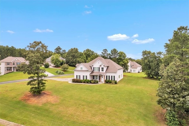 105 Lighthouse Cv SW, Adairsville, GA 30103 - traditional home featuring a front lawn, driveway, and view of scattered trees