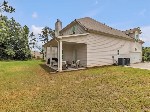 105 Lighthouse Cv SW, Adairsville, GA 30103 - rear view of house featuring a chimney, an outdoor living space, a patio area, a lawn, and driveway