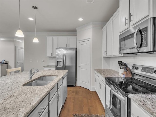 105 Lighthouse Cv SW, Adairsville, GA 30103 - kitchen with stainless steel appliances, decorative backsplash, white cabinets, hanging light fixtures, and recessed lighting