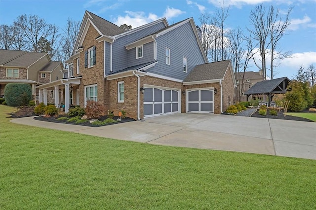 view of front of property with concrete driveway, brick siding, a front lawn, and an attached garage