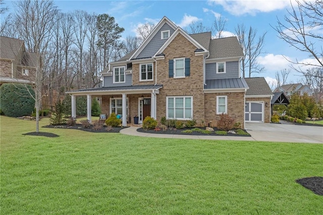 view of front of property with a standing seam roof, covered porch, a front lawn, concrete driveway, and metal roof